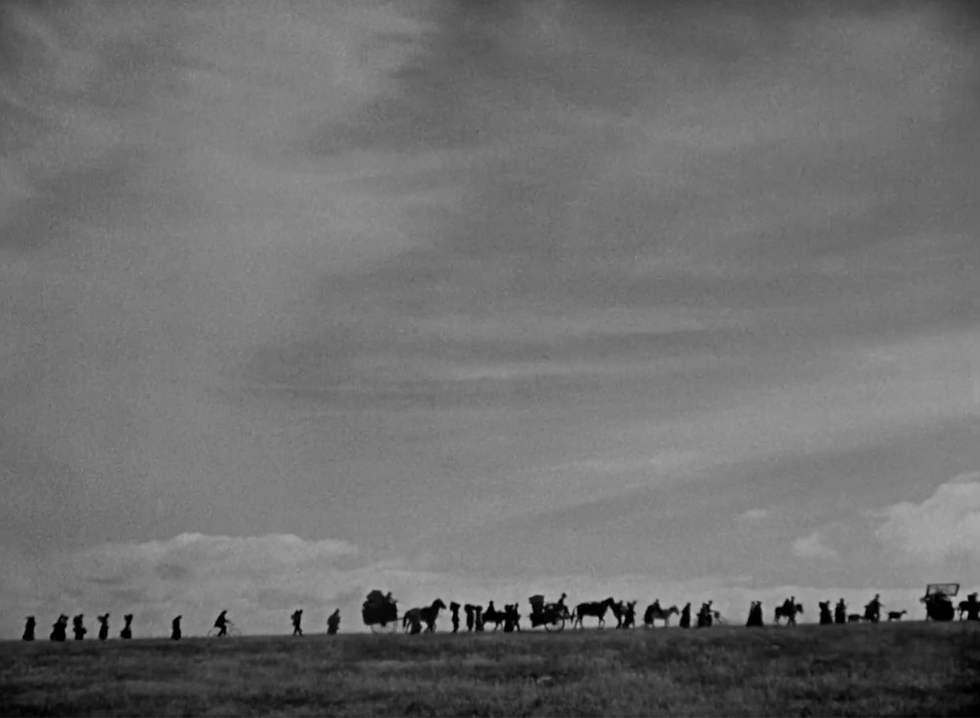 People displaced from war march in line in the World War I epic romance classic Hollywood movie silent film "The Big Parade"