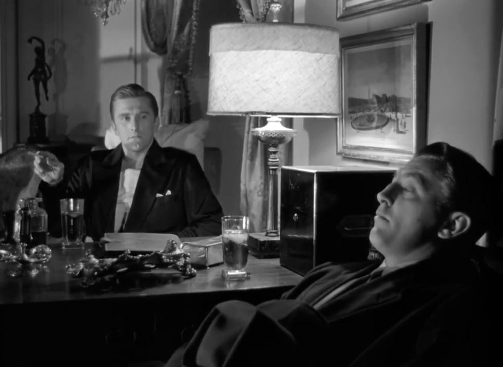 Kirk Douglas hired gumshoe Robert Mitchum in the quintessential classic film noir film crime drama thriller movie "Out of the Past"