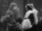 Two women in elegant fur stoles face each other in a vintage setting, one holding a clutch. The mood is formal and sophisticated. Theresa Harris and Barbara Stanwyck in the Hollywood Pre-Code film sexy racy classic movie "Baby Face"