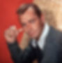 Color portrait photo of Hollywood movie star film tough guy Alan Ladd with cigarette