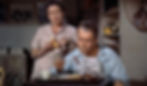Man eats breakfast in a blue shirt while a woman in pink holds toast. They seem thoughtful. Shelves with books in the background. Thelma Ritter eats toast and talks about murder as James Jimmy Stewart eats breakfast in the Alfred Hitchcock classic Hollywood film suspense voyeuristic movie "Rear Window" Peeping Tom