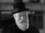 Smiling elderly man with a beard in a black coat and hat against a blurred, dark city background, exuding a warm, friendly mood. Edmund Gwenn stars as Kris Kringle in the classic movie Hollywood holiday Christmas Santa Claus film "Miracle on 34th Street"