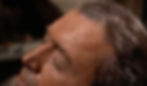 Close-up of a man's face sweating, eyes closed, with damp dark hair. The background is blurred, conveying an intense or stressful mood. James Jimmy Stewart is sweating from the heatwave in the Alfred Hitchcock classic Hollywood film suspense voyeuristic movie "Rear Window" Peeping Tom