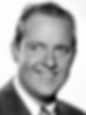 Smiling man in a suit, black-and-white portrait, neutral background. His expression is friendly and confident. Portrait photo of classic Hollywood movie TV star gay character film actor young Grady Sutton