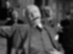 Man in court, sitting relaxed with a cigar in his mouth, wearing a suit. Others seated in the background. Black and white image. William Frawley as a gruff politician in the classic movie Hollywood holiday Christmas Santa Claus film "Miracle on 34th Street"