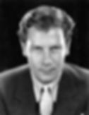 Black and white portrait of a man in a suit with a patterned tie, looking directly at the camera. Dark background, serious expression. Portrait photo of classic Hollywood film actor Western movie star young romantic leading man Joel McCrea