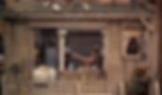 Woman in pink exercise clothes stretching in front of an open window on a rooftop terrace with pigeons. Bed and lamp visible inside. Cozy vibe. Georgine Darcy is Miss Torso ballet dancer in the Alfred Hitchcock classic Hollywood film suspense voyeuristic movie "Rear Window" Peeping Tom