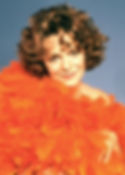 Portrait photo of young actress director Estelle Parsons, in orange feathers