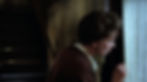 A person looks intently through a gap in a curtain in a dimly lit hallway. The scene conveys curiosity or tension. Audrey Christies spies on her daughter in the classic 1960s Hollywood film romance movie about sex and repression, "Splendor in the Grass"