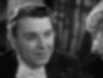 Black-and-white image of a man in a suit looking serious. Neutral background with blurred curtains. 1930s style, dramatic mood. Geroge Brent in the Hollywood Pre-Code film sexy racy classic movie "Baby Face"