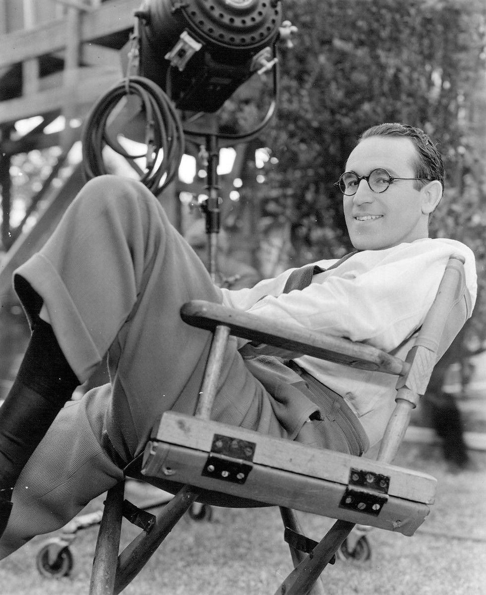 Actor movie star Hollywood icon silent film comedy legend Harold Lloyd sits in a director's chair