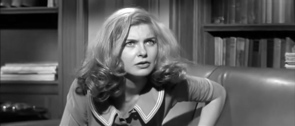 Woman with wavy hair sits on a couch, looking focused. Background features bookshelves. Black and white image creates a classic mood. Joanne Woodward stars in her Oscar-winning Best Actress role in the classic Hollywood psychological drama movie about multiple split personality dissociative identity disorder  "The Three Faces of Eve" as Eve White