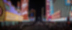 Night scene of a vibrant Las Vegas street, lined with colorful neon signs for casinos and hotels. Crowds gather along the sidewalks. Las Vegas in the early 1960s in the classic 1960s Elvis Presley rocking MGM movie musical "Viva Las Vegas".