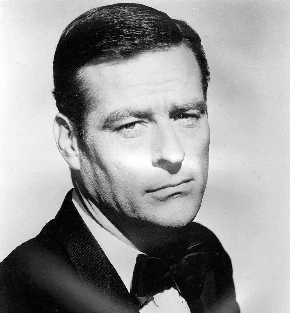 Black and white portrait of a man in a suit and bow tie, with a serious expression. Plain background enhances the classic, formal mood. Portrait photo of Hollywood character movie star film actor TV younger Robert Webber
