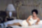 Elizabeth Taylor on a brass bed in negligee in a scene from Tennessee Williams' classic film drama movie "Cat on a Hot Tin Roof"