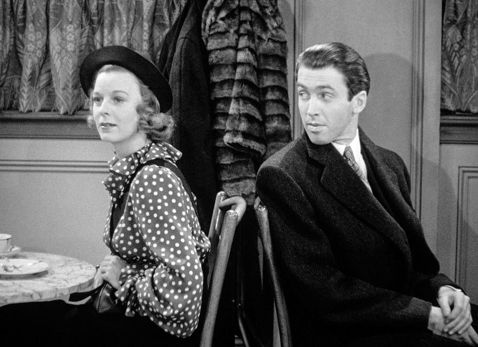 Margaret Sullavan and James Stewart sit in booths at a cafe in the classic Ernst Lubitsch movie Hollywood romantic comedy film "The Shop Around the Corner"
