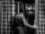 Man in a checkered robe looks out a window at another person standing on a patio. Striped curtains frame the scene. Black and white image. Gloria Grahame and Humphrey Bogart look at each other across their apartment courtyard in the classic Hollywood movie romance Nicholas Ray film noir "In a Lonely Place"