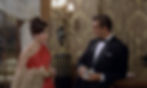 Woman in a red evening gown faces a man in a tuxedo holding cash in an ornate room, their tense conversation underway. Eunice Gayson and Sean Connery flirts in the casino in the first classic James Bond movie espionage spy thriller 007 film 1962 "Dr. No"