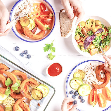 Flat lay of family hands eating healthy food. Vegan lunch table top view_edited.jpg