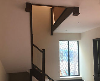 Freshly painted hallway and staircase area with timber beams and glass panels in a Newbury property