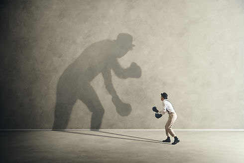man fighting with his shadow, facing fears.jpg