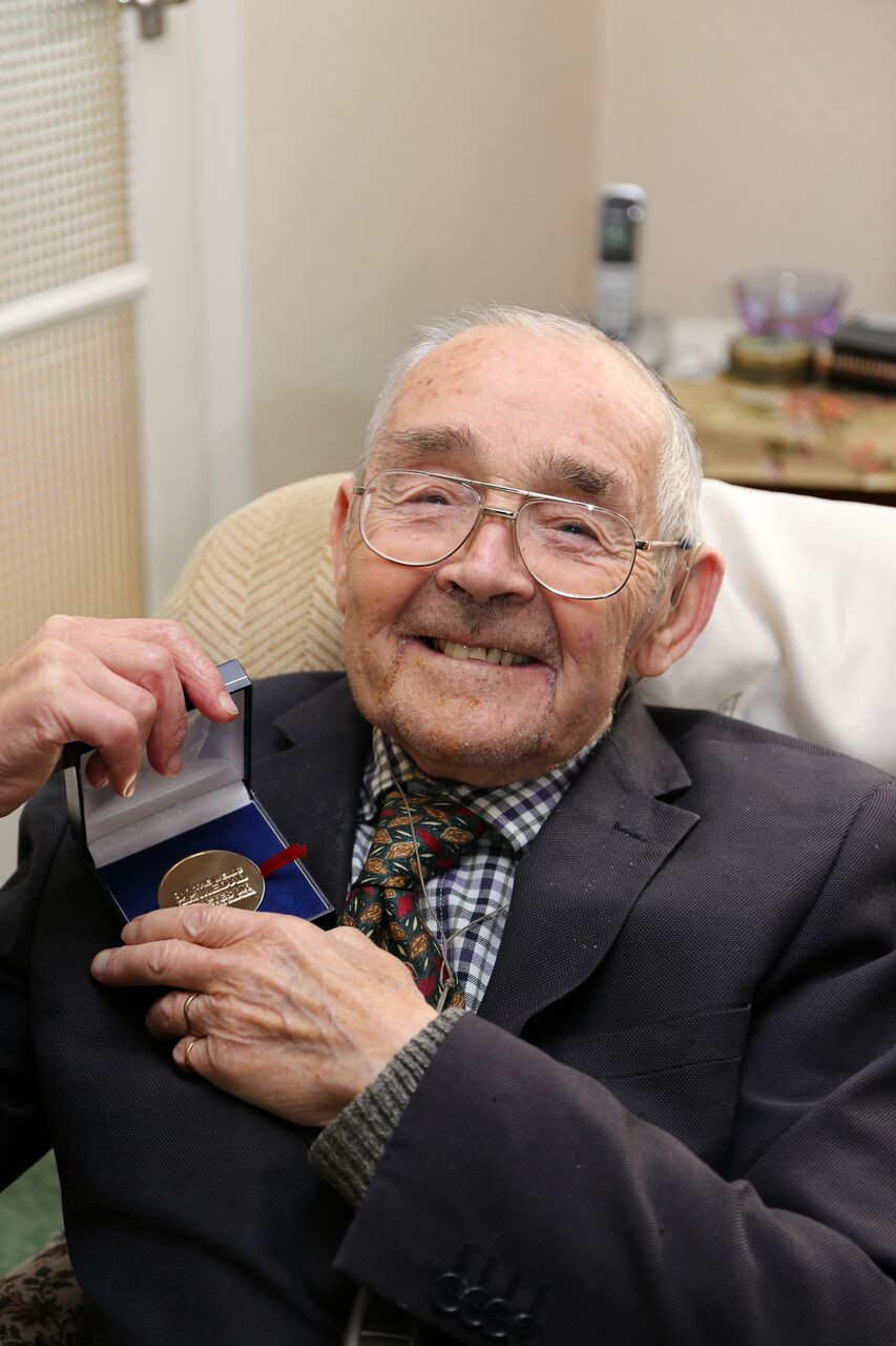 Clifford Whittaker being presented a medal from Diabetes UK