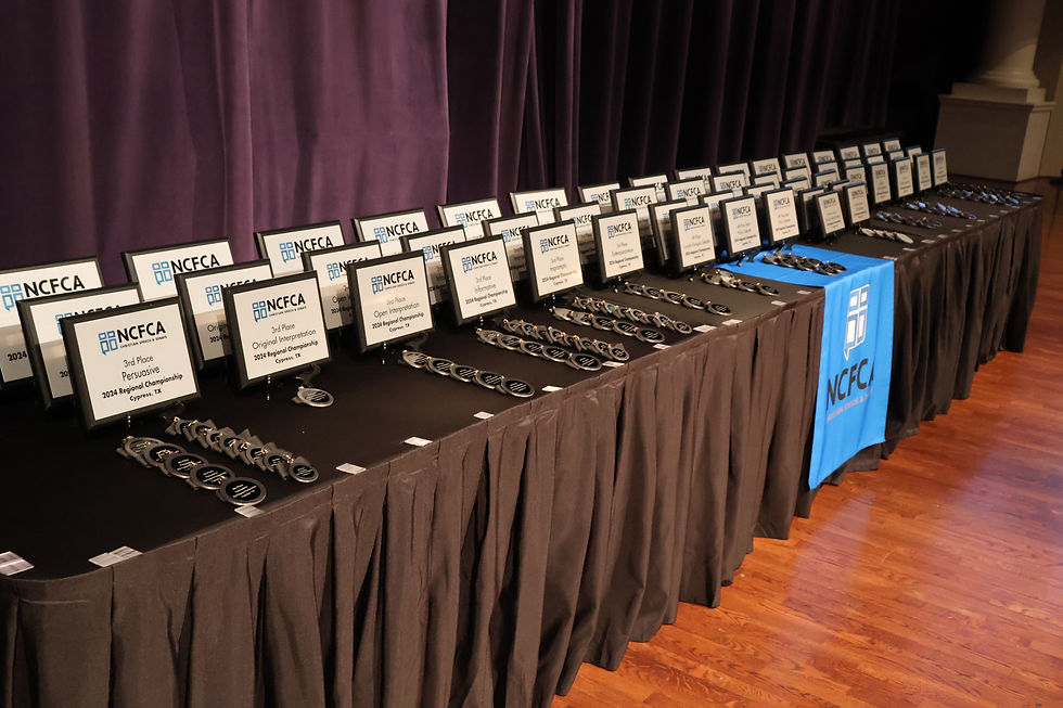 Tables lined with awards at a speech and debate tournament
