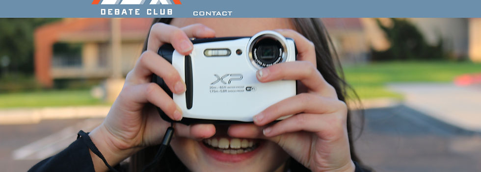Young girl grinning behind camera