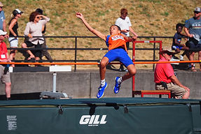 athlete arching over a high jump bar