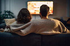 rear-view-loving-couple-watching-tv-home_compressed.jpg