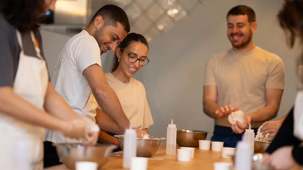 Group of bakers preparing ingredients at a dough-making workshop at ALBA Zurich — part of BYCA Zurich’s curated culinary highlights.
