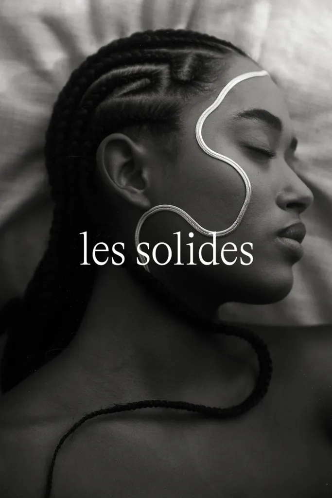 Portrait of a woman wearing minimalist jewelry by Les Solides, featured on BYCA.
