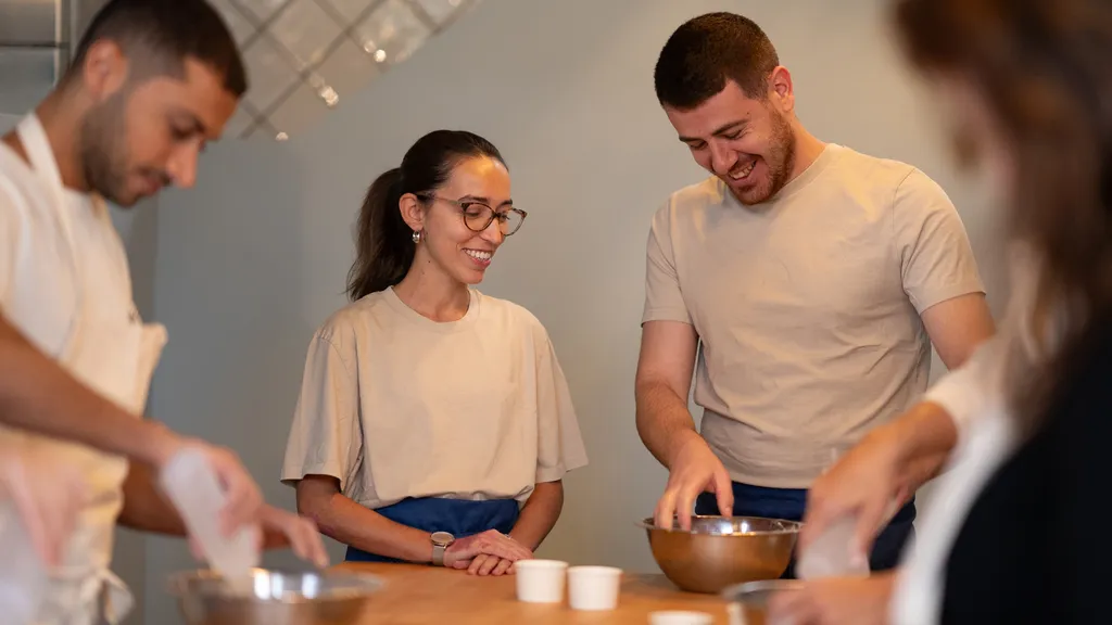 Group of bakers preparing ingredients at a dough-making workshop at ALBA Zurich — part of BYCA Zurich’s curated culinary highlights.