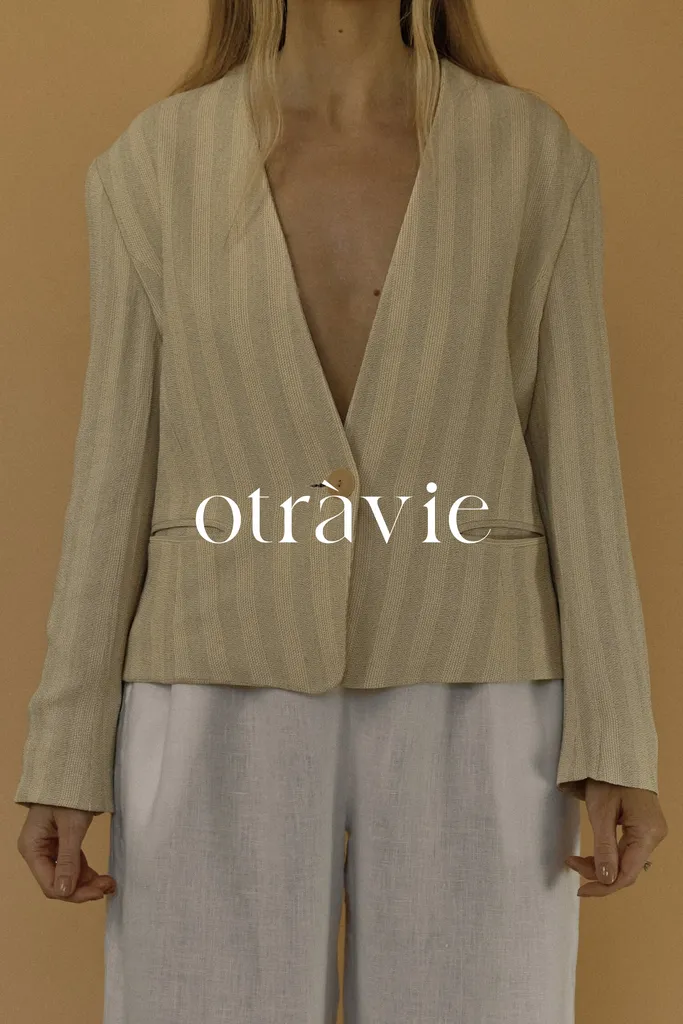 Model in striped beige blazer by Otràvie, featured on BYCA.