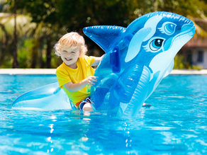 Child Swimming with a Whale Floaty