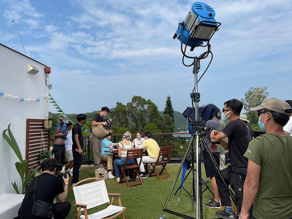 Lighting team setting up professional lights for Darlie's outdoor shoot.