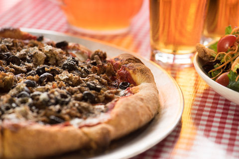 Close up pizza, beer and salad