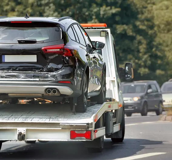 damaged-vehicle-tow-truck-city-street.webp