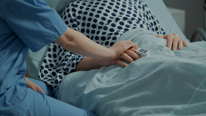 close-up-nurse-comforting-ill-patient-hospital-ward.jpg