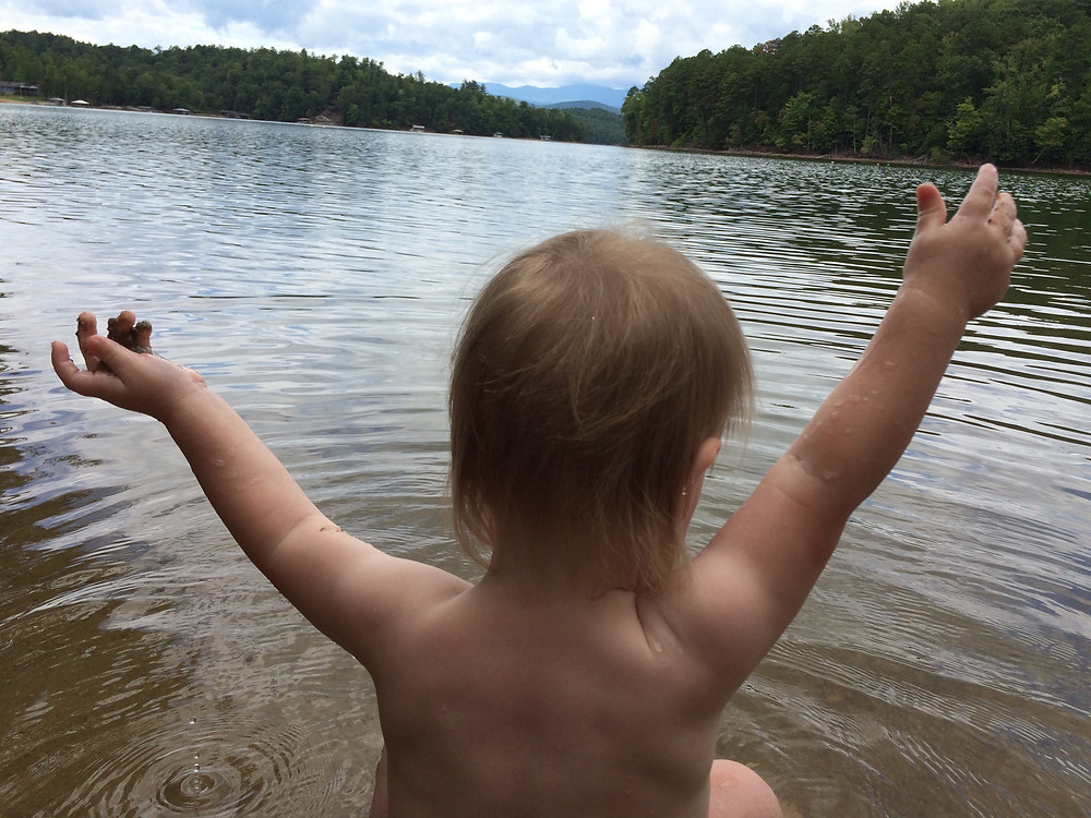 My daughter playing the lake for the first time.