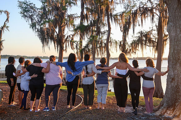 Community of women healing on a lake