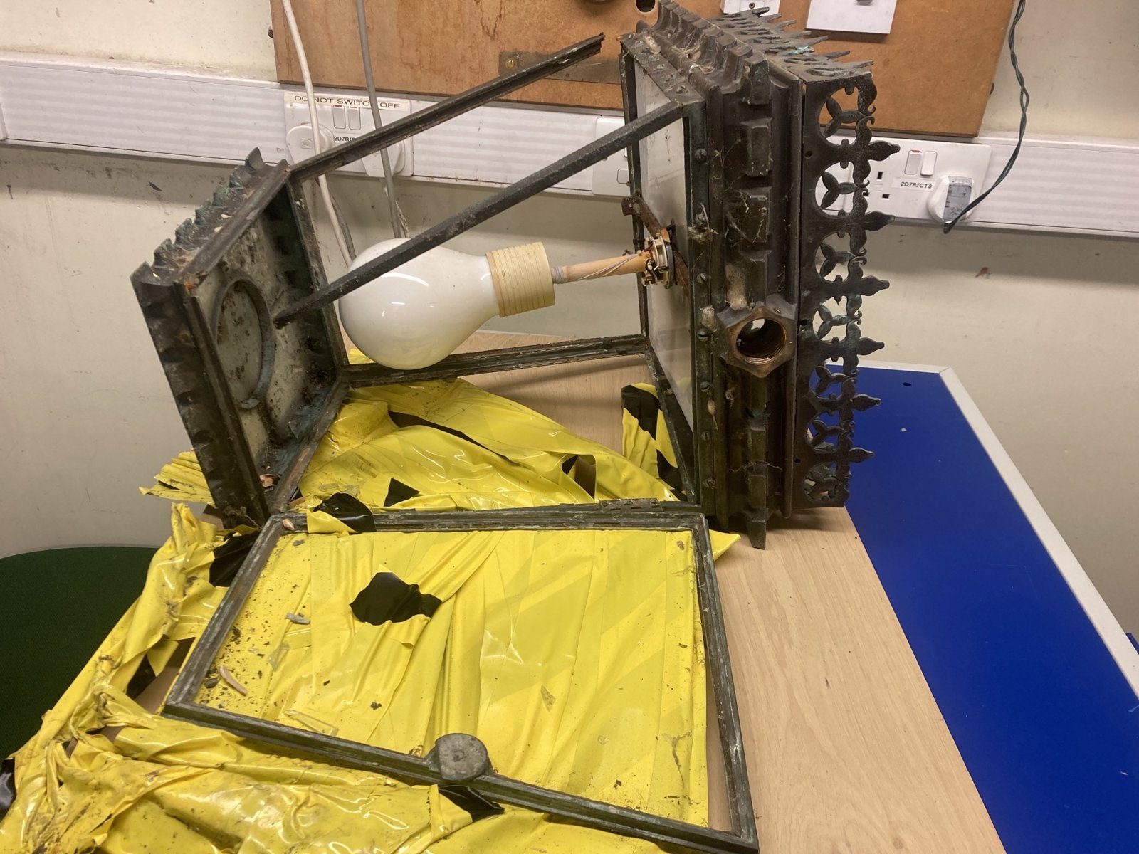 Lantern dismantled to its frame and glass panels in the workshop