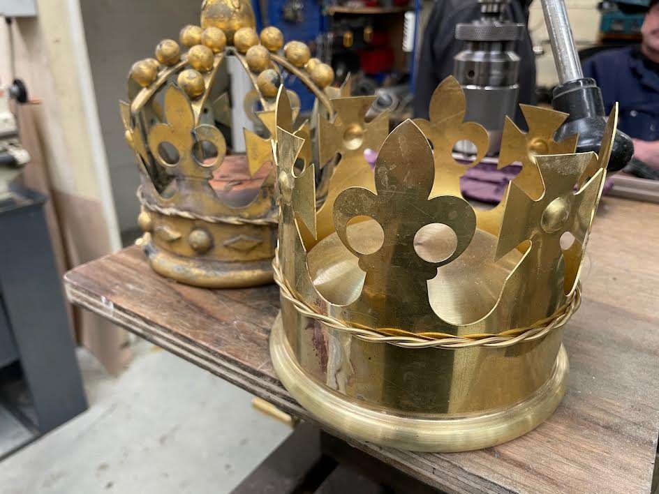Two crowns side by side, the original and the new brass crown