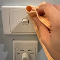 Cleaning light switches and fan controls for end of lease inspection in Keysborough