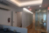 Finished commercial office corridor with new hardwood flooring and glass conference room in Washington DC.