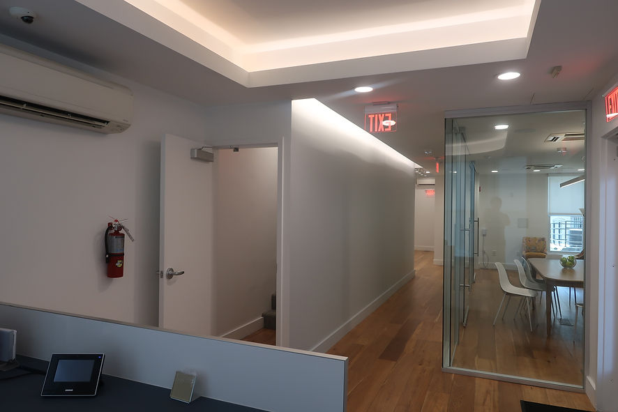 Finished commercial office corridor with new hardwood flooring and glass conference room in Washington DC.