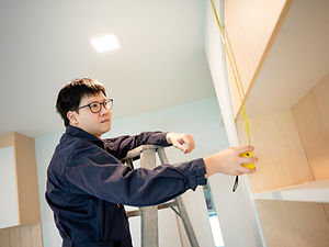 a man measure cabinet