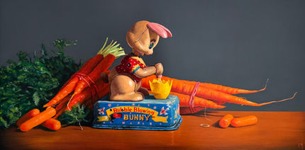 An old metal bunny toy with 18 carrots on a wood table with a gold ring.