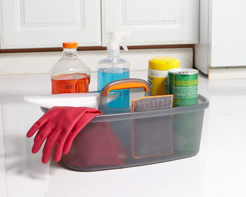 Caddy filled with assorted cleaning supplies including spray bottles, disinfectant, sponges, and gloves—ready for maintaining a clean and sanitized space