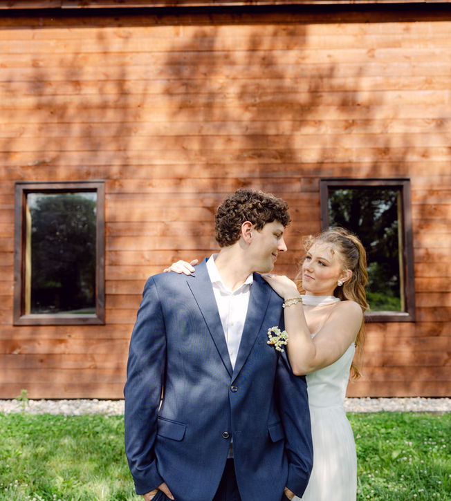 Couple posing outside the boutique barn at Rotherwood Events